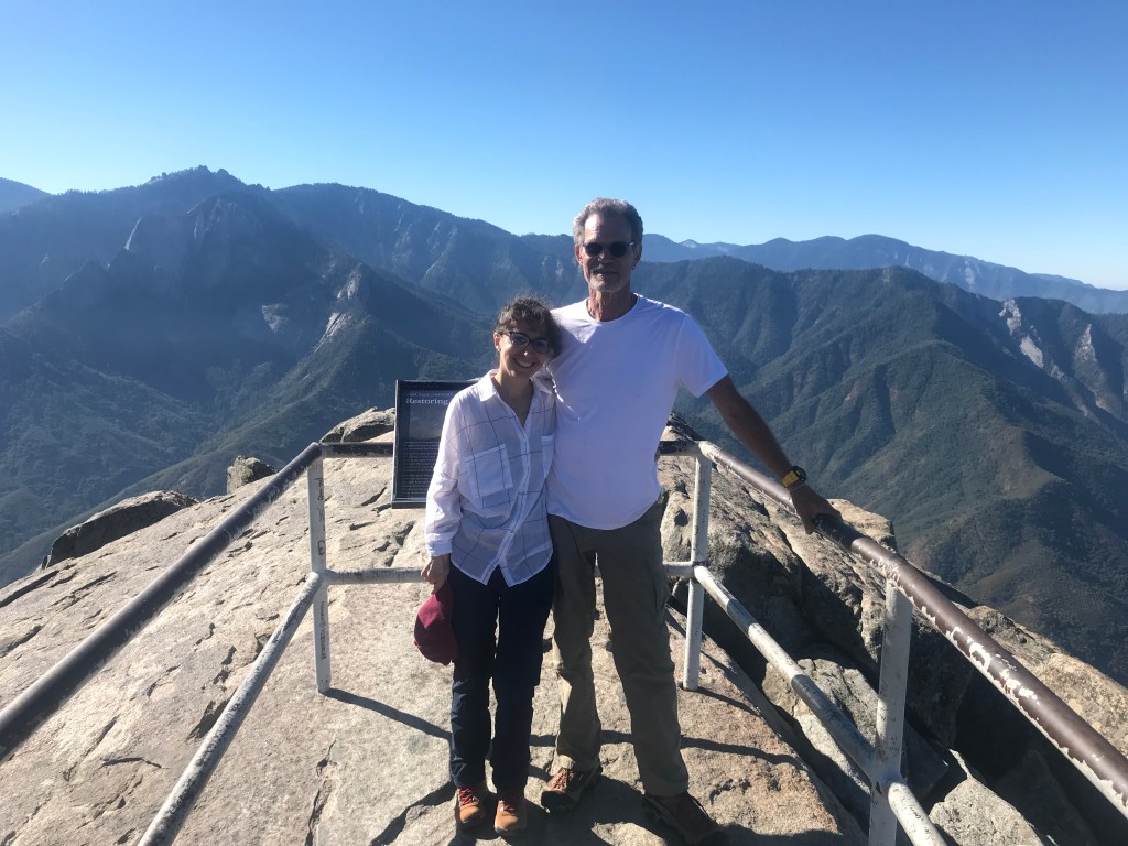 two people in love on top of Moro rock in Sequoia... climbing mountains together
